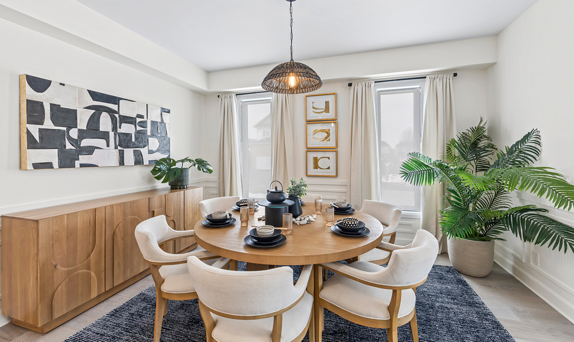 A sunny sitting area with two big windows and space for a sideboard, a table, six chairs, and a large plant.