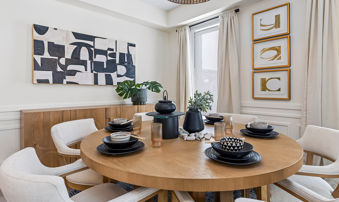 A dining room table set for dinner.