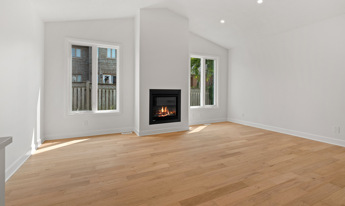 Living room with vaulted ceiling and fireplace