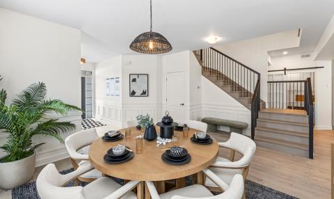 A sunny sitting area is situated near the bottom of a wide staircase.