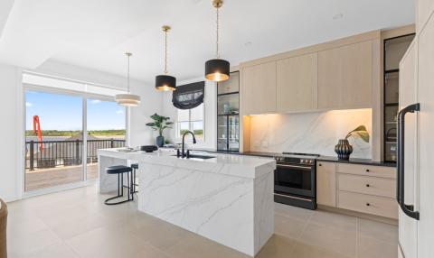 An open-concept kitchen with big sliding doors leading out to a wide balcony.