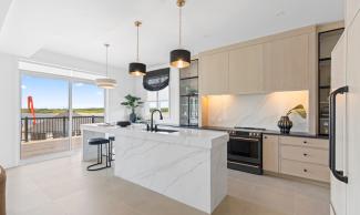An open-concept kitchen with big sliding doors leading out to a wide balcony.