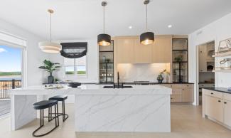 An open-concept kitchen with a pantry closet and sliding doors leading out to a porch.